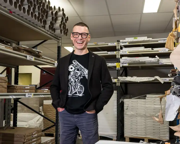 Leon Wilson, Revolution Print's chief print geek, laughing in the warehouse